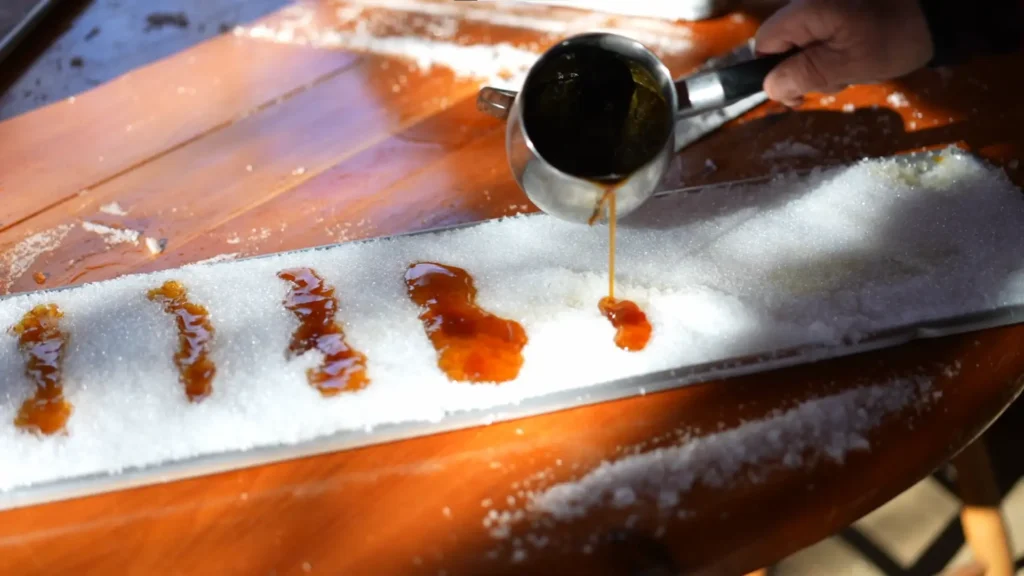 Pouring maple taffy onto snow